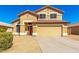 Charming two-story home featuring a red tile roof, beige stucco, and attached two-car garage at 6410 W Hughes Dr, Phoenix, AZ 85043