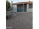 Side yard with storage shed, barrel, and wheelbarrow at 6449 E Dodge St, Mesa, AZ 85205