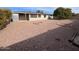 Large backyard with gravel landscaping and covered patio at 6449 E Dodge St, Mesa, AZ 85205