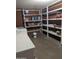 Unfinished basement with shelving and laundry hookups at 6449 E Dodge St, Mesa, AZ 85205