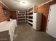 Clean and bright basement with shelving and storage at 6449 E Dodge St, Mesa, AZ 85205