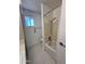 Clean bathroom with a shower-tub combination, a window and classic hexagon tile flooring at 6449 E Dodge St, Mesa, AZ 85205