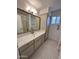 Bathroom features a marble countertop, white cabinetry, and decorative mirror at 6449 E Dodge St, Mesa, AZ 85205