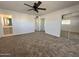 Bedroom with neutral carpet, mirrored closet and ensuite bathroom at 6449 E Dodge St, Mesa, AZ 85205