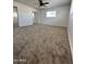 Spacious bedroom with neutral carpet, windows and mirrored closet at 6449 E Dodge St, Mesa, AZ 85205