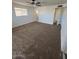 Spacious carpeted bedroom with ample closet space and ceiling fan at 6449 E Dodge St, Mesa, AZ 85205