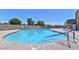 Inviting kidney-shaped community pool with lounge chairs at 6449 E Dodge St, Mesa, AZ 85205