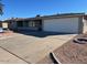 Single story home with attached garage and landscaped yard at 6449 E Dodge St, Mesa, AZ 85205