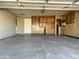 Spacious garage featuring storage cabinets, concrete flooring, and a functional door at 6449 E Dodge St, Mesa, AZ 85205