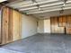 Well-lit garage showcasing ample space, a garage door, and convenient side door access at 6449 E Dodge St, Mesa, AZ 85205