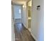 Hallway with tile flooring and a view into the bathroom with white walls and tile flooring at 6449 E Dodge St, Mesa, AZ 85205