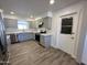 Modern kitchen with stainless steel appliances, gray cabinetry, and vinyl flooring at 6449 E Dodge St, Mesa, AZ 85205