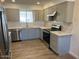 Updated kitchen with stainless steel appliances and light gray cabinets at 6449 E Dodge St, Mesa, AZ 85205