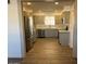 Modern kitchen with stainless steel appliances and gray cabinets at 6449 E Dodge St, Mesa, AZ 85205