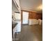 Functional laundry room with a sink, washer, and dryer, complemented by brick wall accents at 6449 E Dodge St, Mesa, AZ 85205