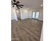 Spacious living room features stylish wood flooring and a modern ceiling fan at 6449 E Dodge St, Mesa, AZ 85205