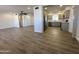 Open-concept space showcasing seamless vinyl flooring, a modern ceiling fan, and grey cabinets at 6449 E Dodge St, Mesa, AZ 85205