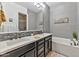 Elegant bathroom with double vanity and soaking tub at 6565 E Thomas Rd # 1015, Scottsdale, AZ 85251