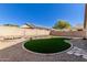 Landscaped backyard with artificial turf and stone pathway at 6612 W Paso Trl, Phoenix, AZ 85083