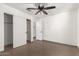 Bedroom with tile floors, ceiling fan, and a closet at 6612 W Paso Trl, Phoenix, AZ 85083