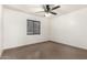 Well-lit bedroom featuring tile floors and a ceiling fan at 6612 W Paso Trl, Phoenix, AZ 85083