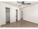 Bedroom with tile floors, ceiling fan and closet at 6612 W Paso Trl, Phoenix, AZ 85083