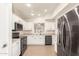 Modern kitchen with white cabinets and stainless steel appliances at 6612 W Paso Trl, Phoenix, AZ 85083