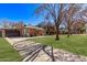 Quaint brick home with lush green lawn and a welcoming front porch seating area at 6811 N 11Th Ave, Phoenix, AZ 85013