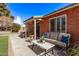 Cozy front porch with brick facade, comfortable seating, and lush landscaping at 6811 N 11Th Ave, Phoenix, AZ 85013