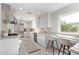 Bright kitchen featuring white cabinets, stainless steel appliances, and a breakfast bar at 6811 N 11Th Ave, Phoenix, AZ 85013