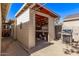 Open shed with space for storage and work area, accompanied by a grill outside, ideal for outdoor activities at 6811 N 11Th Ave, Phoenix, AZ 85013