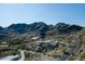 Aerial view of a unique, circular home nestled in the mountains at 6836 N 36Th St, Phoenix, AZ 85018