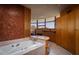 Relaxing bathroom with a large soaking tub, marble countertops, and copper tile at 6836 N 36Th St, Phoenix, AZ 85018