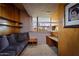 Comfortable bedroom with built-in seating, wood paneling, and a window showcasing the view at 6836 N 36Th St, Phoenix, AZ 85018