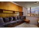 Cozy bedroom with a built-in sofa, wood shelving, and a view of the desert landscape at 6836 N 36Th St, Phoenix, AZ 85018