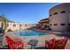 Curved pool with red patio furniture and desert landscaping at 6836 N 36Th St, Phoenix, AZ 85018