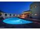 Curved pool with patio furniture at dusk at 6836 N 36Th St, Phoenix, AZ 85018