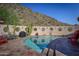 Inviting curved pool with patio furniture and mountain backdrop at 6836 N 36Th St, Phoenix, AZ 85018