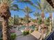 Luxury backyard with a pool, spa, waterfall, and palm trees at 6876 S Star Dr, Gilbert, AZ 85298