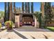 Covered outdoor patio with comfortable seating, lush landscaping, and elegant stone flooring and pillars at 6876 S Star Dr, Gilbert, AZ 85298