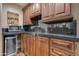 Wet bar with dark wood cabinets, granite countertop, and mini-fridge at 6876 S Star Dr, Gilbert, AZ 85298