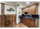 Basement wet bar featuring dark wood cabinetry and a stylish design next to panelled walls at 6876 S Star Dr, Gilbert, AZ 85298