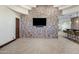 Finished basement offering a brick accent wall, a mounted TV, and a bar area for entertaining at 6876 S Star Dr, Gilbert, AZ 85298