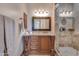 Elegant bathroom with dark wood vanity, frameless shower, and modern fixtures at 6876 S Star Dr, Gilbert, AZ 85298