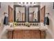 Double vanity bathroom with granite countertop and dark wood cabinets at 6876 S Star Dr, Gilbert, AZ 85298