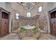 Elegant bathroom with a large soaking tub, stone tile, and a double vanity at 6876 S Star Dr, Gilbert, AZ 85298