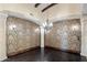 Formal dining room with beautiful chandelier lighting, dark hardwood floors and exquisite wall coverings at 6876 S Star Dr, Gilbert, AZ 85298