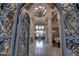 Grand entryway with ornate iron door, high ceilings, and elegant chandelier at 6876 S Star Dr, Gilbert, AZ 85298