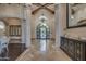 Spacious foyer featuring a decorative door, stone columns, and hardwood floors at 6876 S Star Dr, Gilbert, AZ 85298