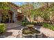 Stone facade entryway with grand fountain, manicured landscaping, and tiled walkway at 6876 S Star Dr, Gilbert, AZ 85298